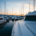 A tranquil marina at sunset with a variety of boats, including a well-maintained yacht, reflecting the importance of boat valuation in the nautical...