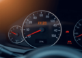 Close-up of a car's dashboard highlighting the odometer and inspection stickers, with a softly blurred background, emphasizing professionalism in v...