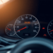 Close-up of a car's dashboard highlighting the odometer and inspection stickers, with a softly blurred background, emphasizing professionalism in v...