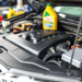 Close-up of a clean car engine with tools and oil change supplies in the background, emphasizing care and maintenance for optimal vehicle performance.