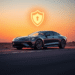 A sleek modern car on an open road at sunset with a glowing shield symbol hovering above, set against warm gradient skies symbolizing protection an...